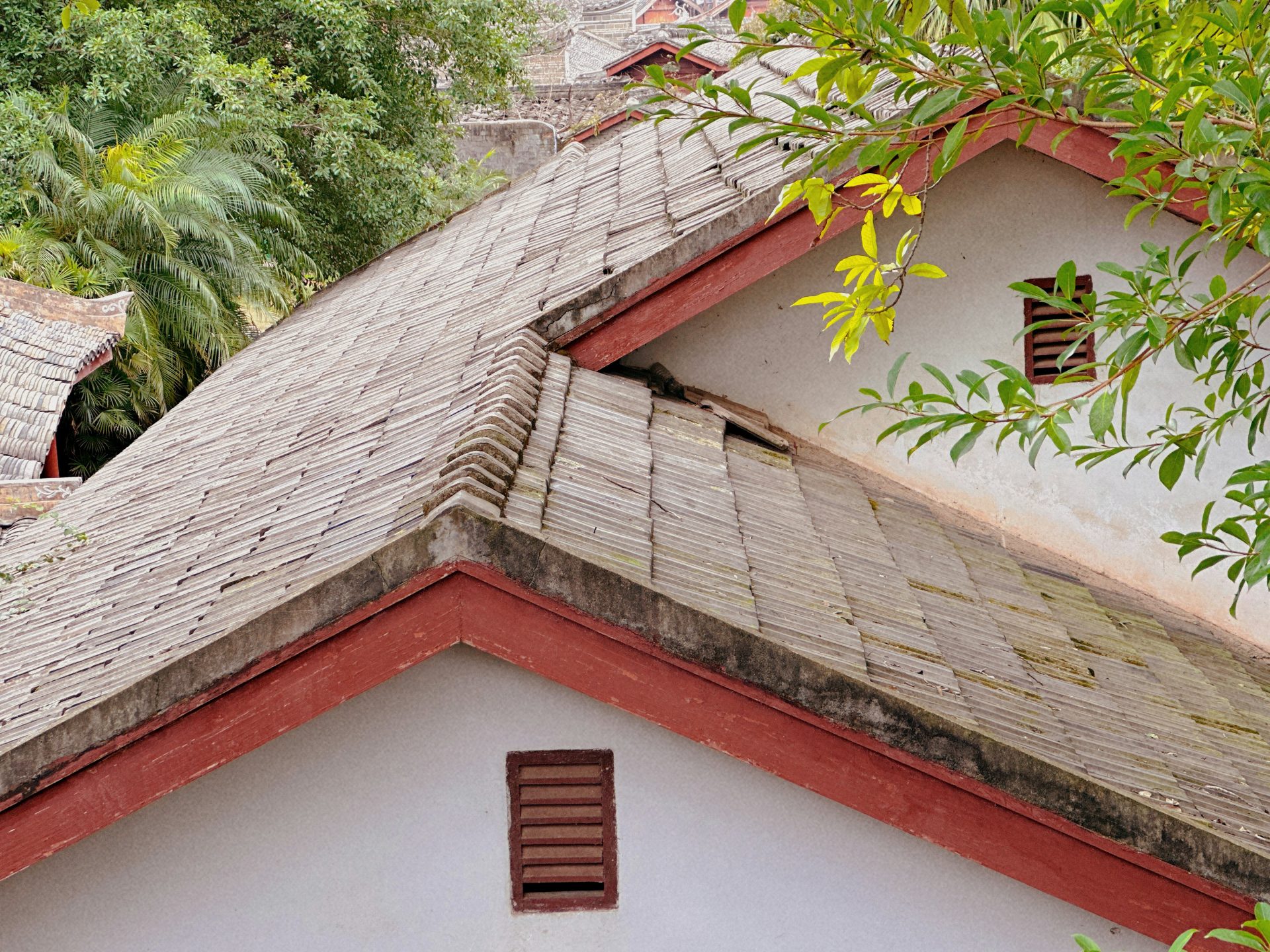 the roof of a house with a bird perched on top of it